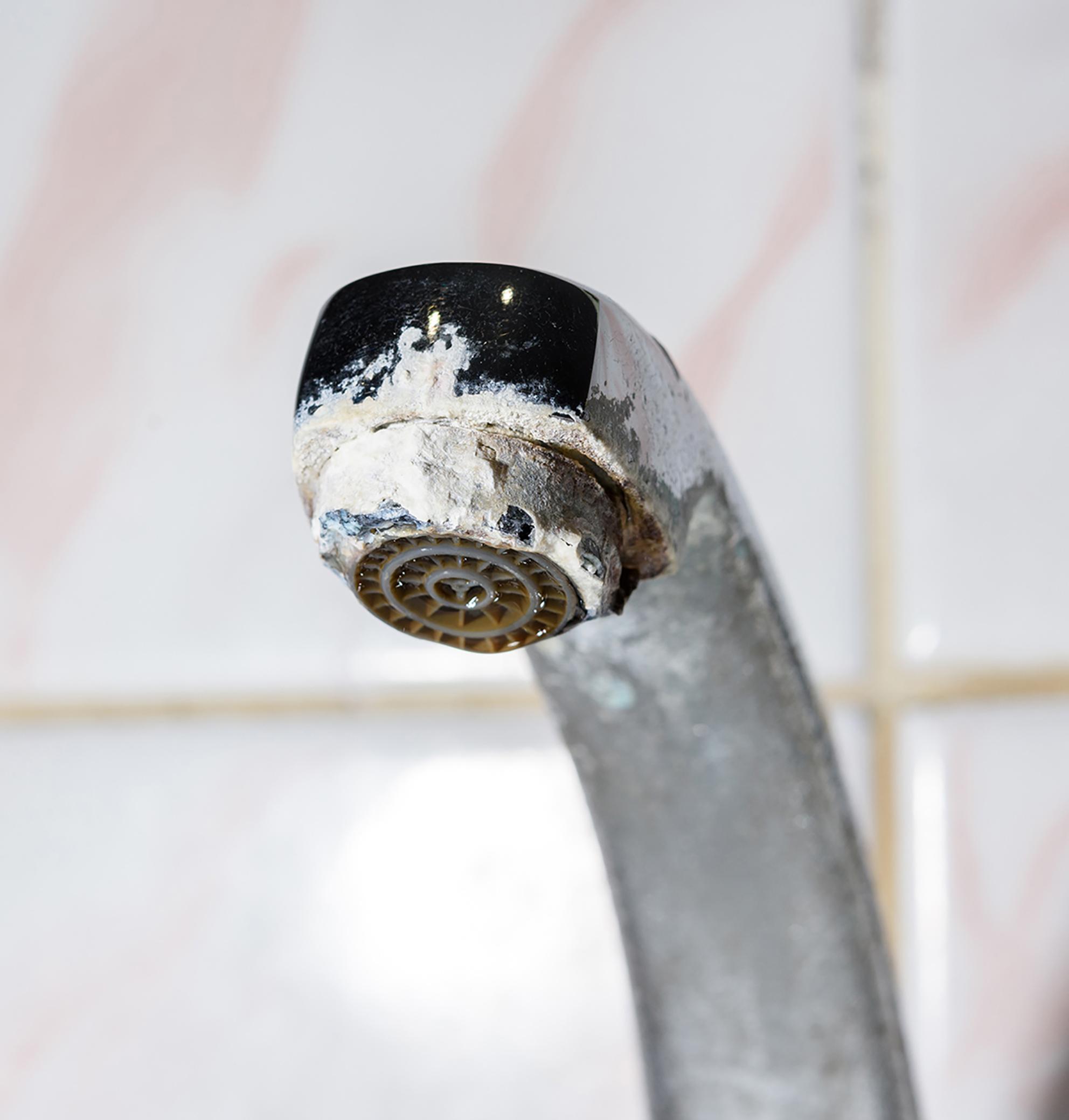 a faucet with scale on it