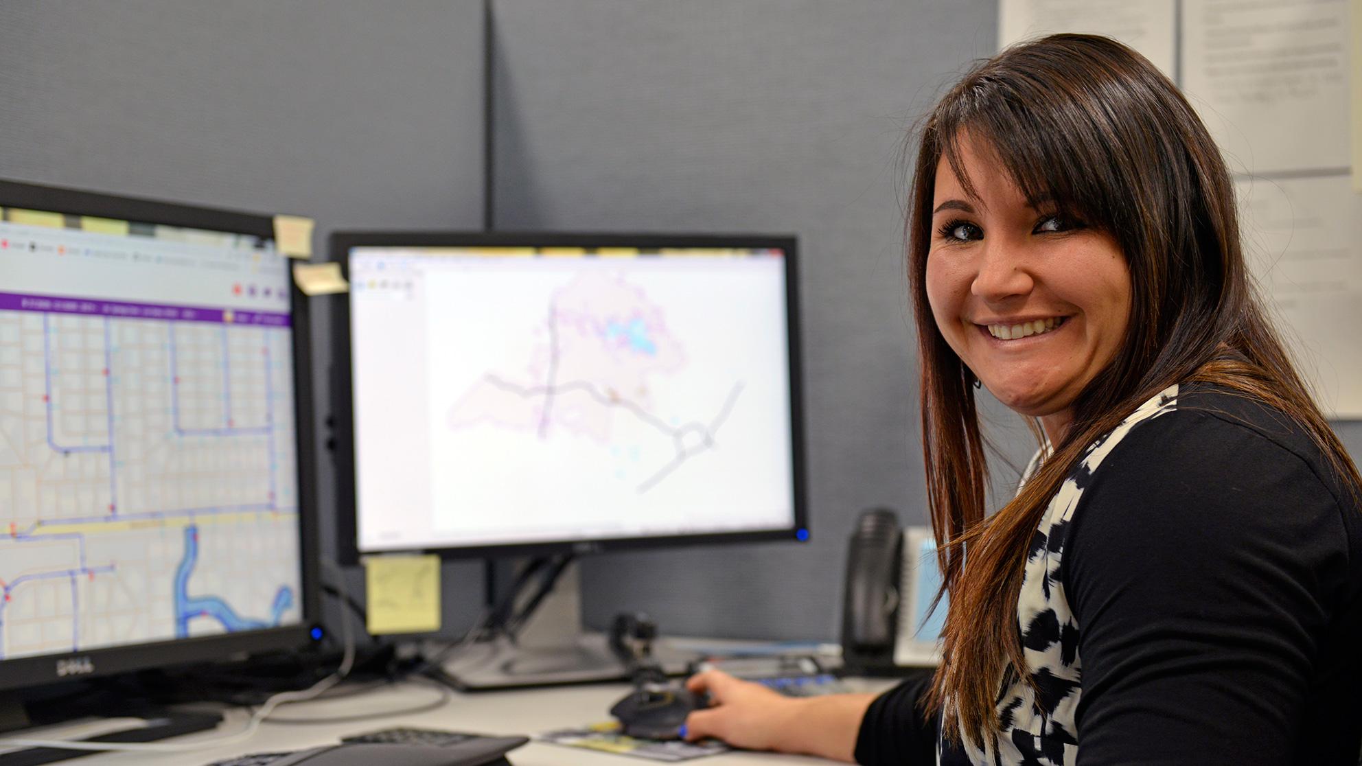 smiling San Jose Water employee at her desk