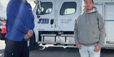 Lucy Perez and Fabian Rosales standing in front of their truck
