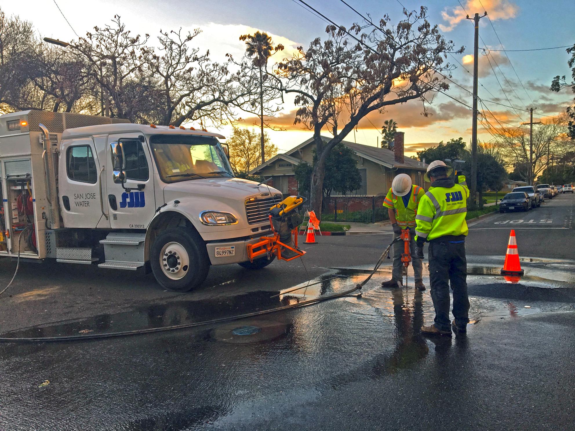 San Jose Water employees working on a broken pipe in road