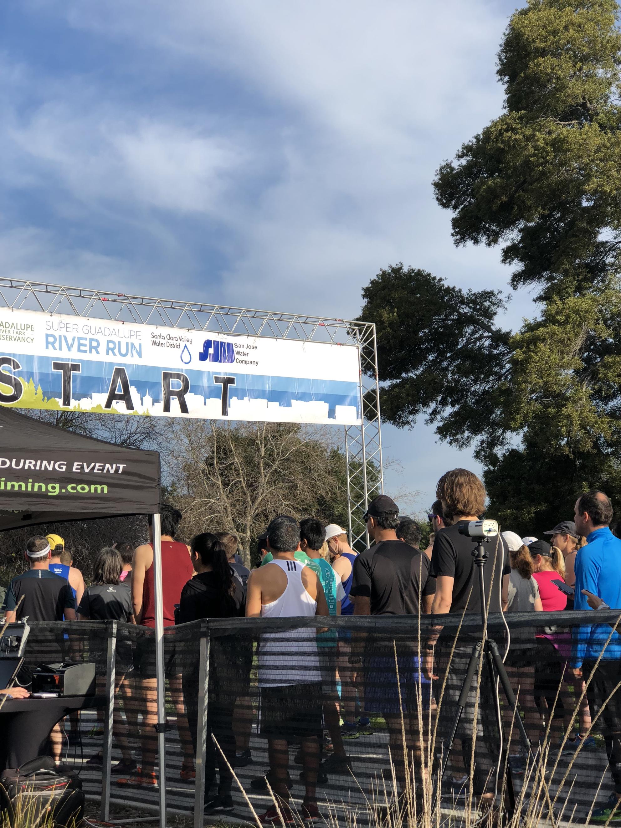 People lined up to run a marathon on a sunny day