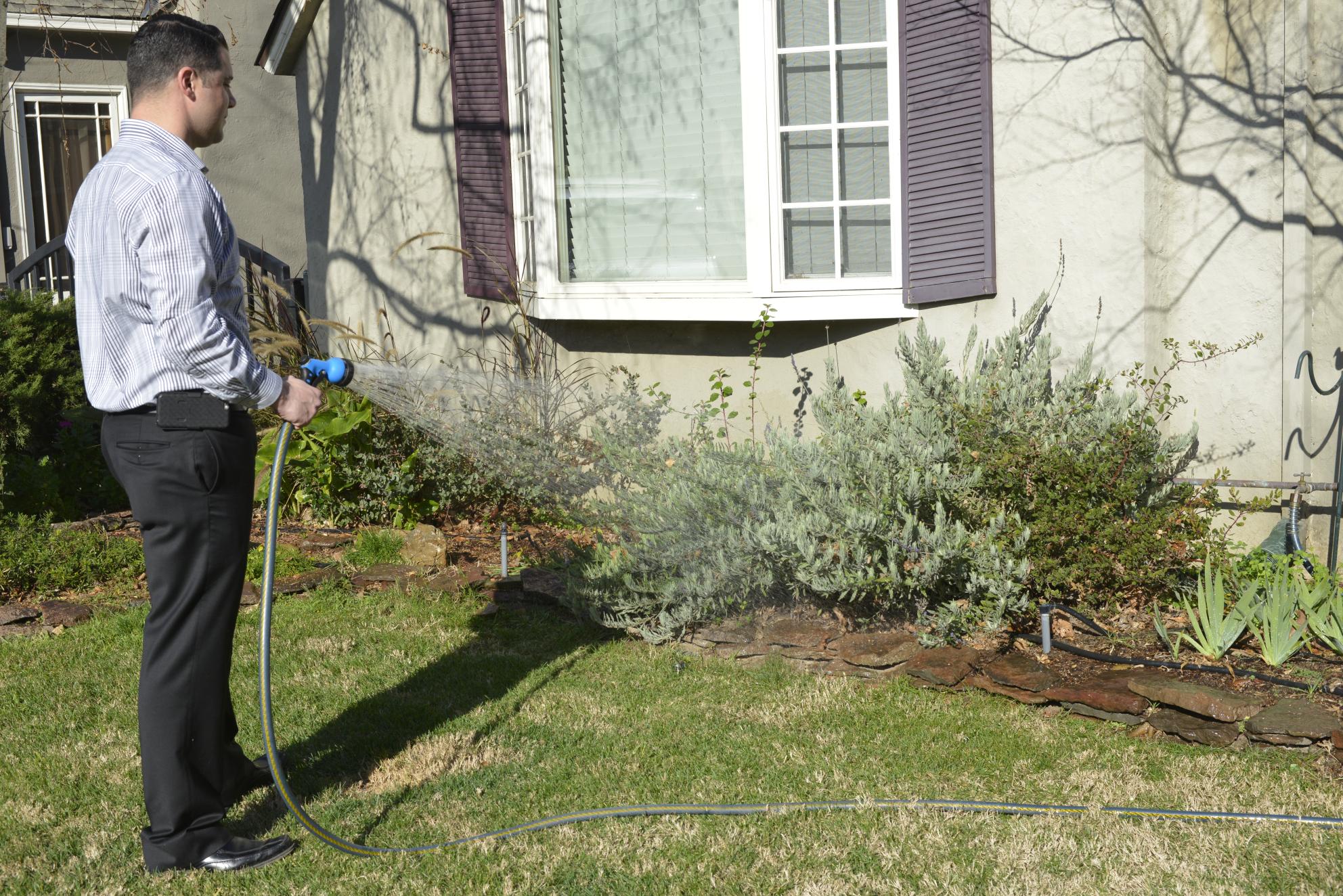 Man holding a garden hose