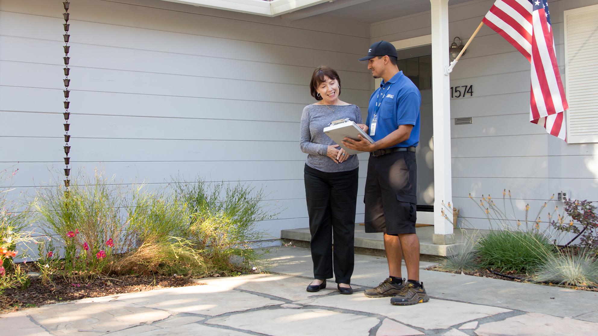 San Jose Water Worker and Customer talk outside a home