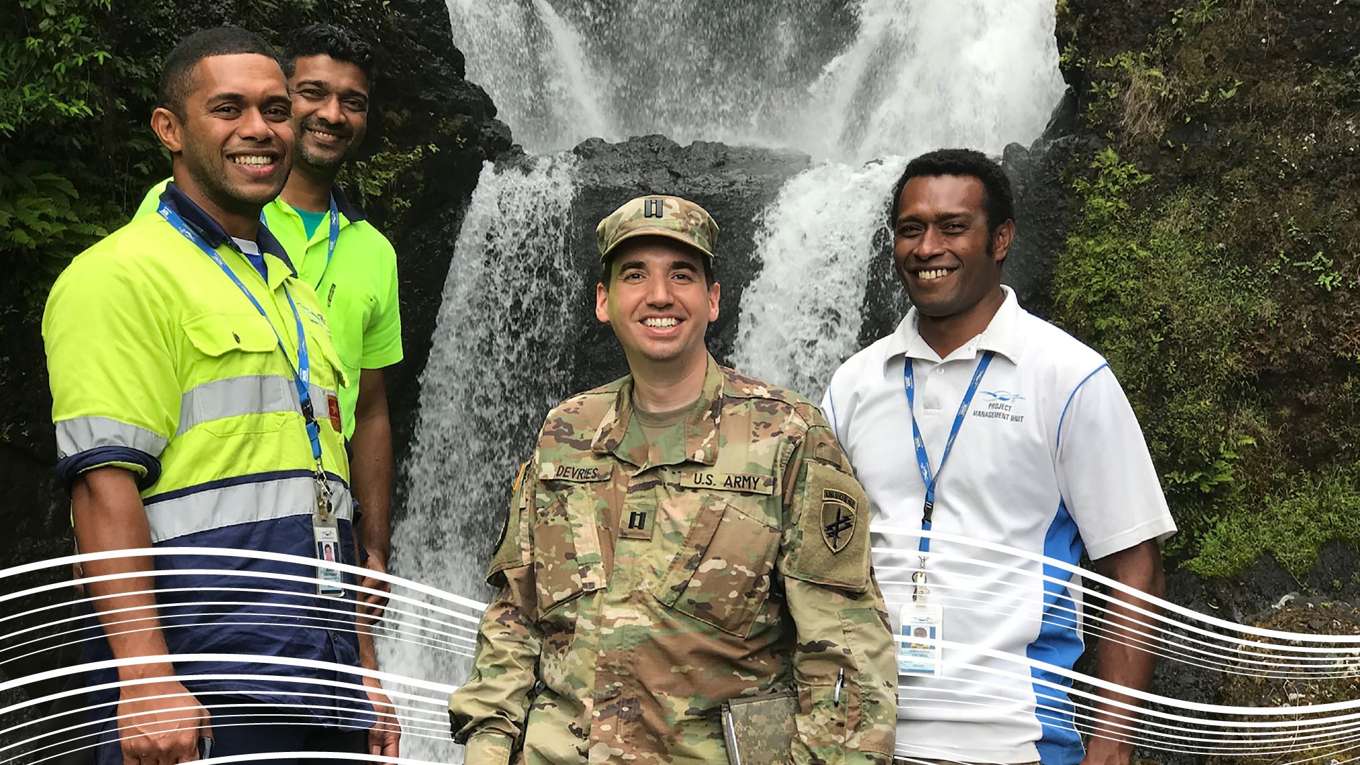 Gavin and friends in front of Fiji waterfall