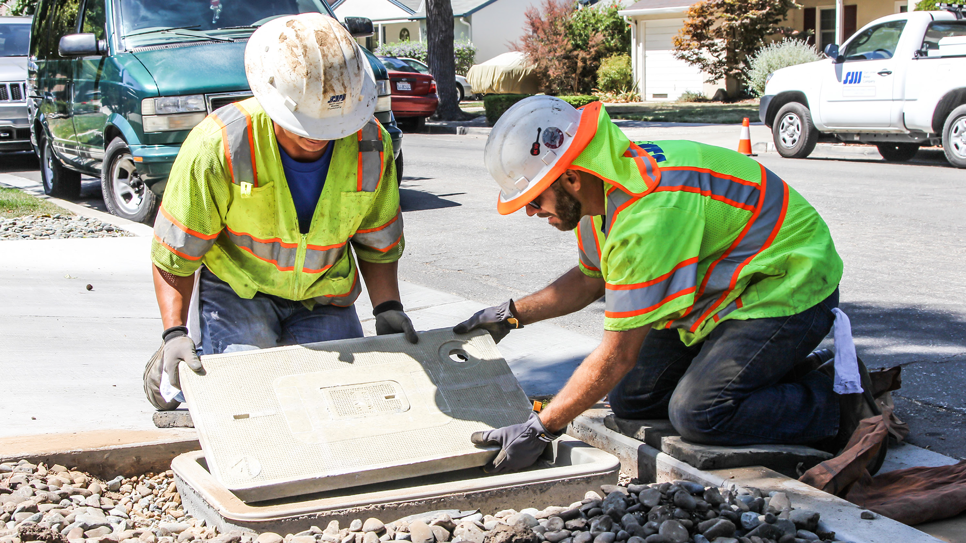AMI-feature-image_1.png SJW workers covering a water shut off valve in front of a house