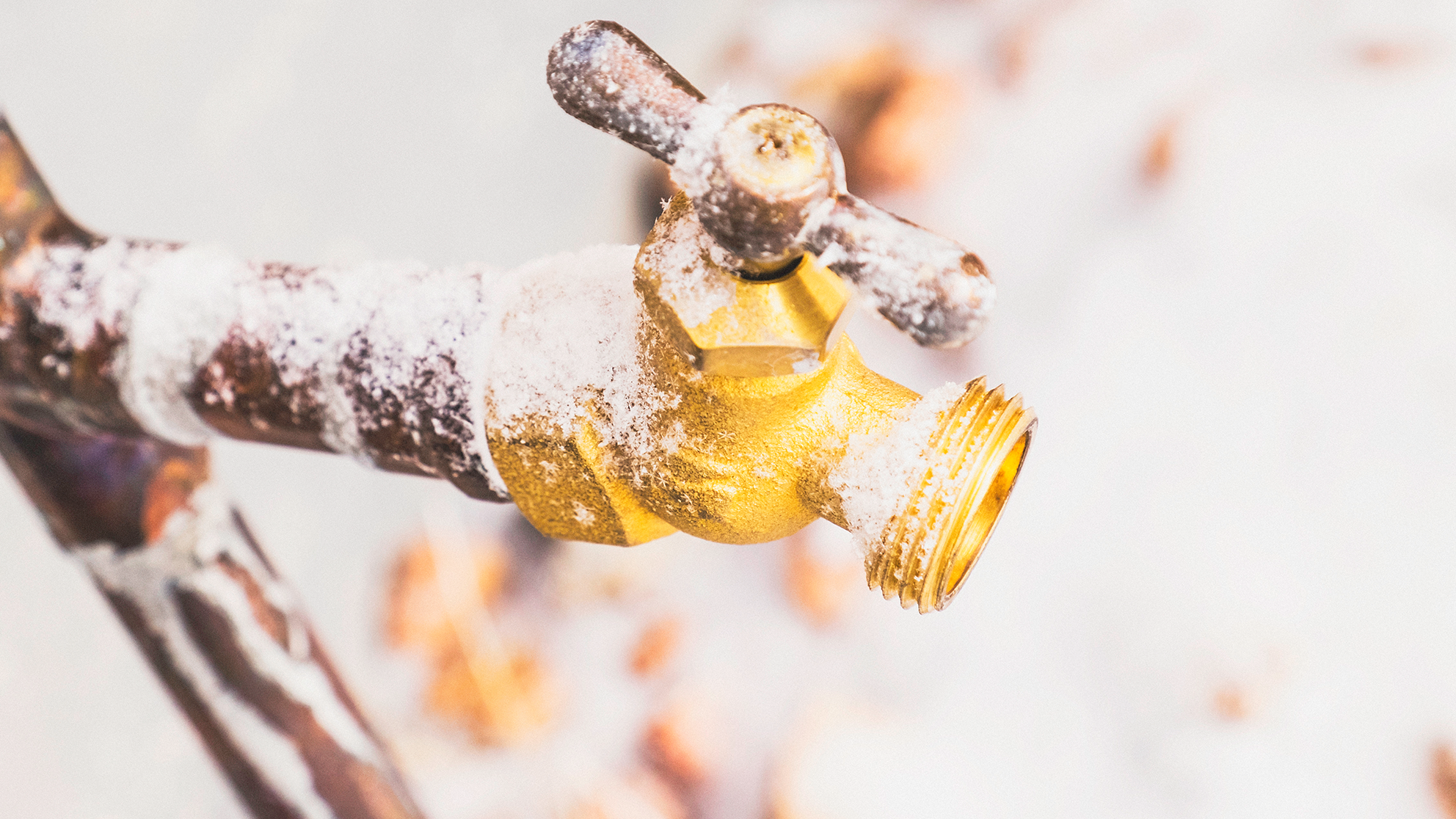 SJW-winter-weather-feature.png Outside water faucet covered in snow outside.
