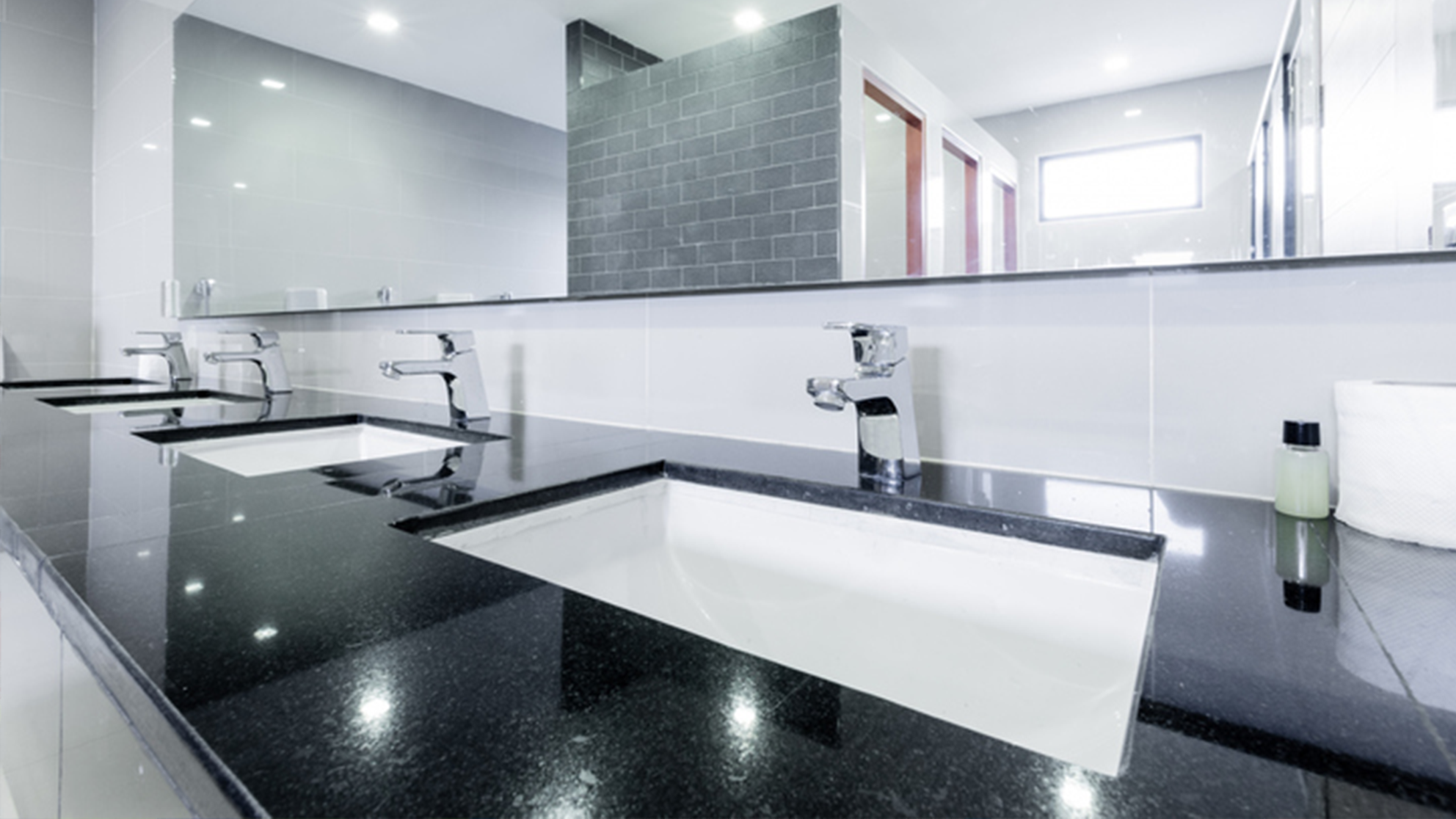COVID-19-Shutdown-feature.png Clean public bathroom sinks and counter.