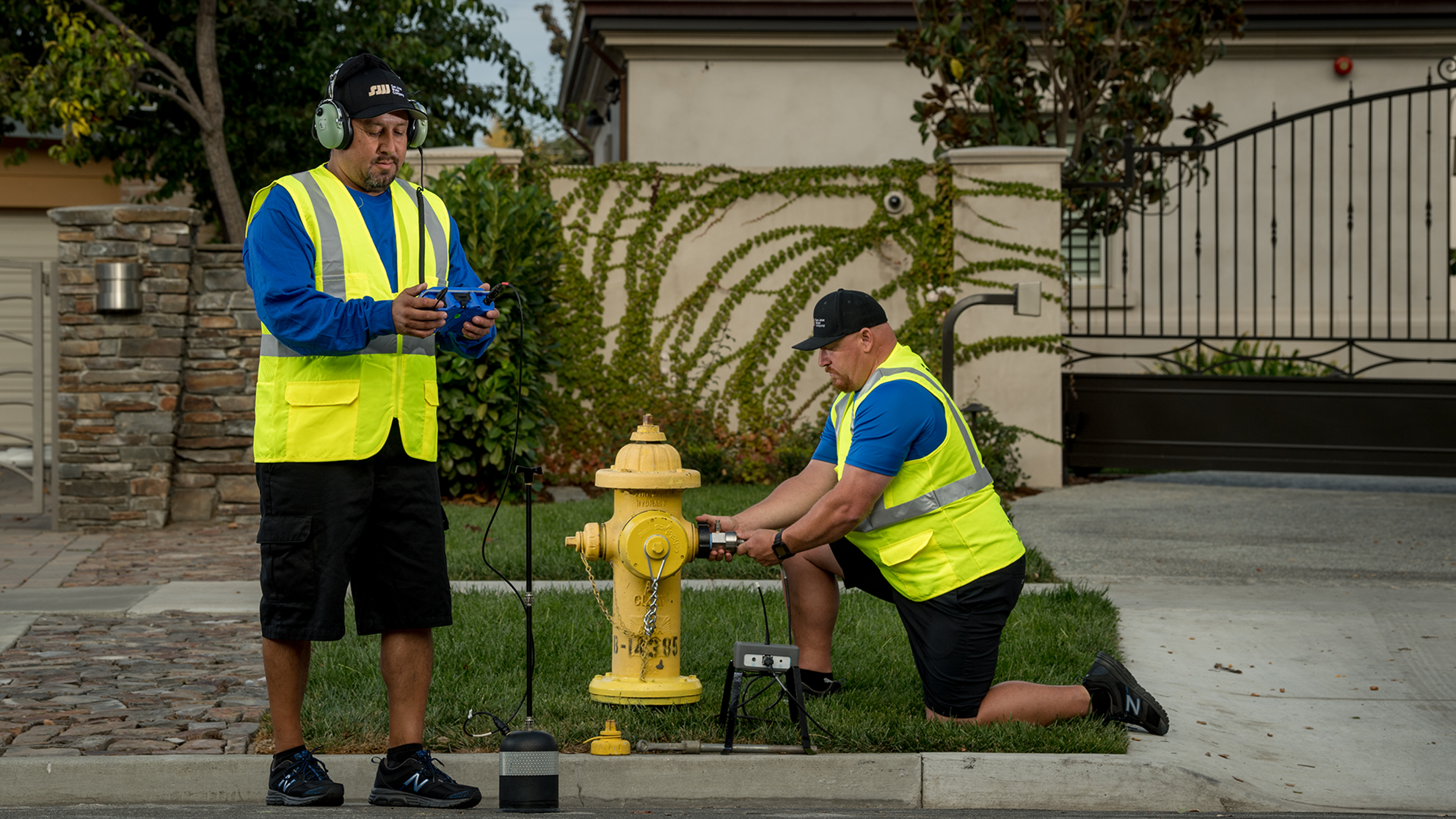 Two male San Jose Water employees checking a residential fire hydrant