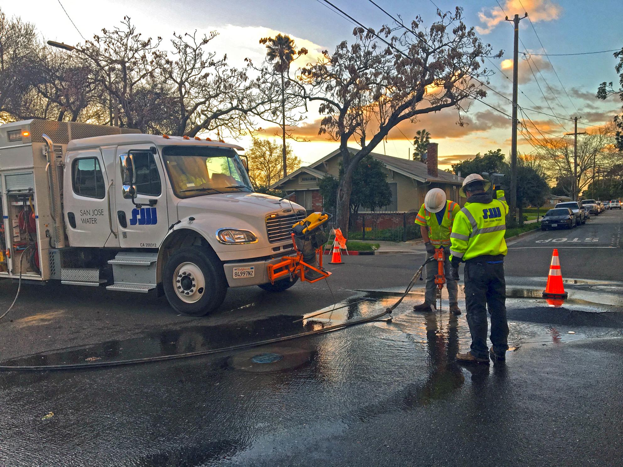 SJW crew fixing a street leak at sunset