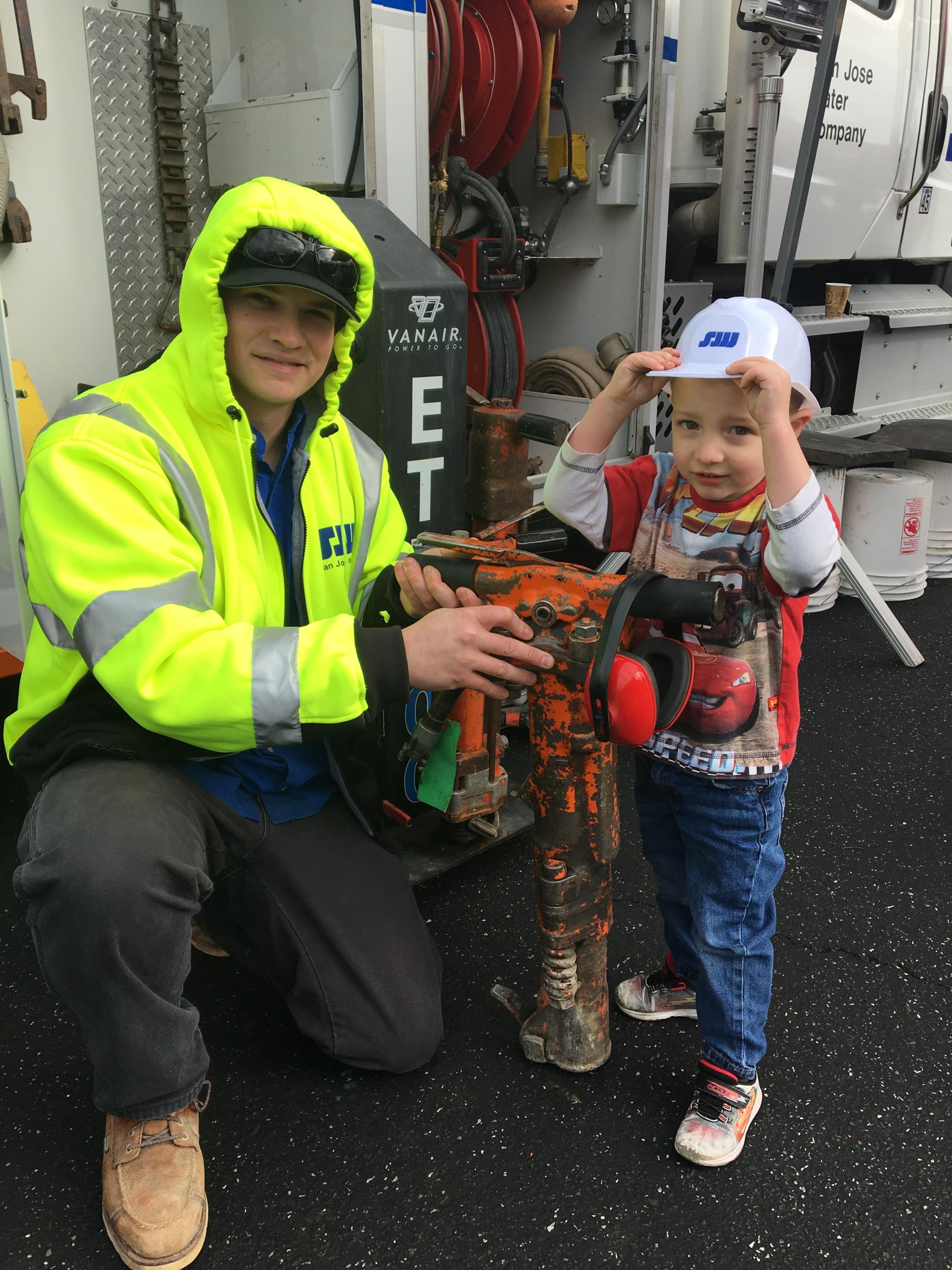 SJW Staff and child at Touch a Truck event