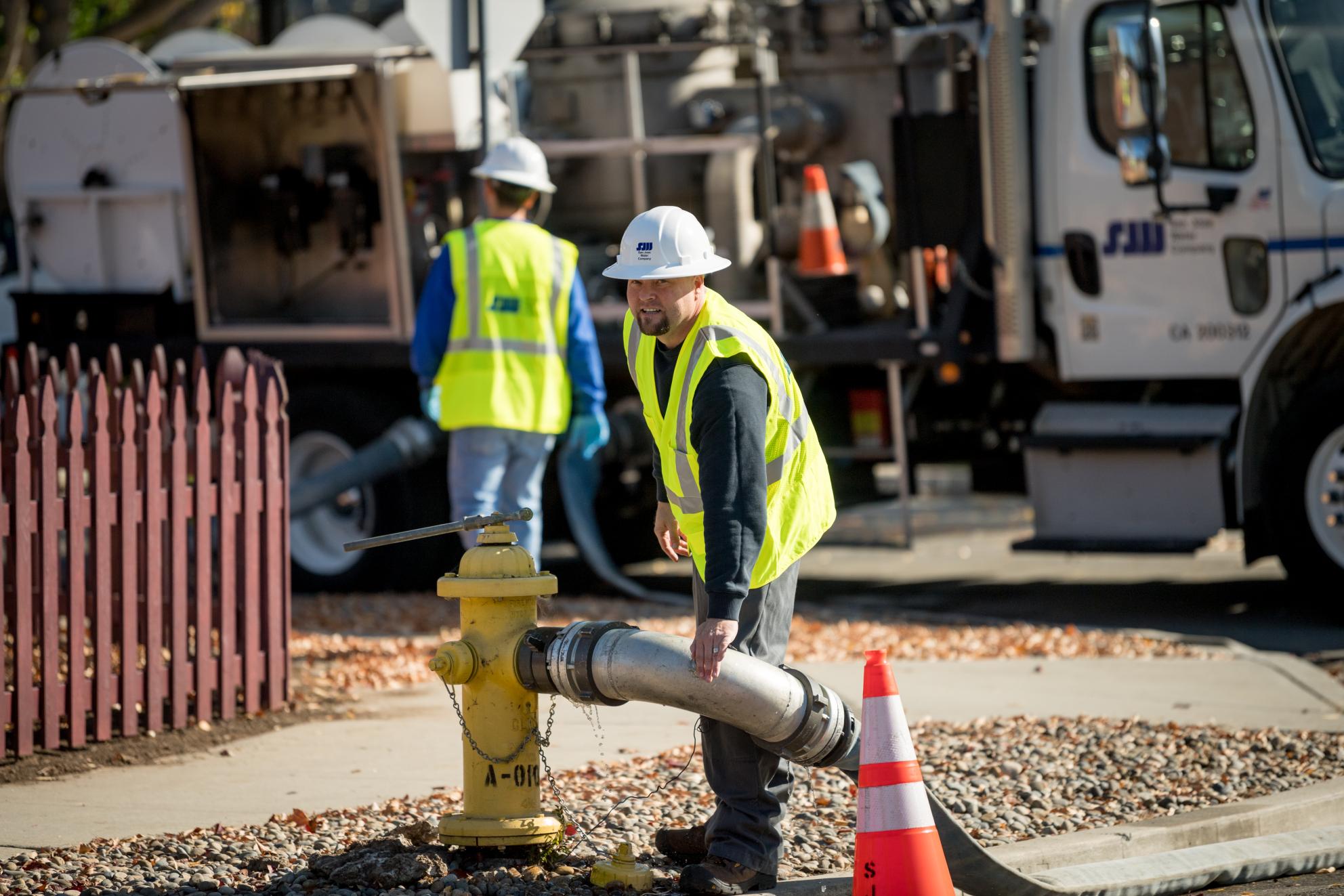 SJW_Source_to_Tap-310.jpg SJW Flushing Truck with Worker adding hose to hydrant