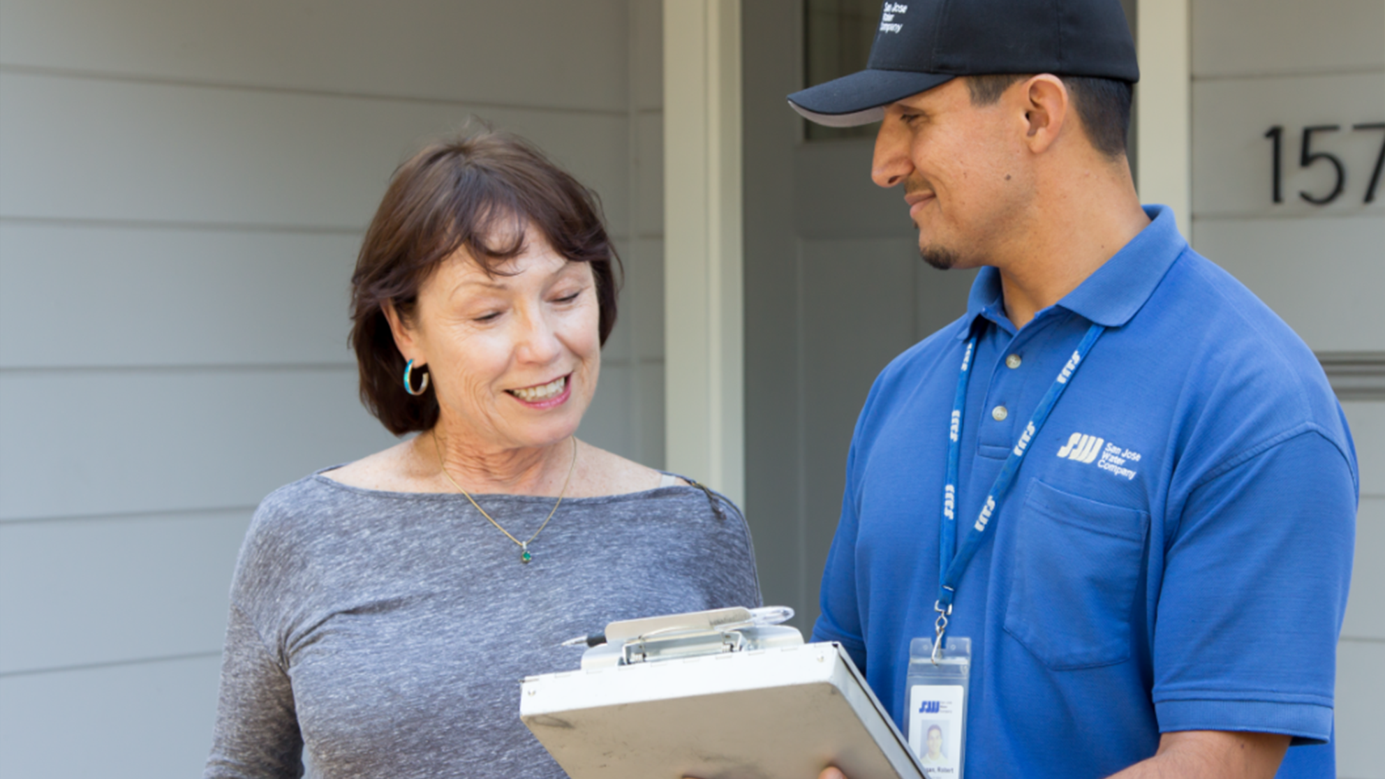 San Jose Water Rates Image - Women being helped by SJW associate in front of her house.