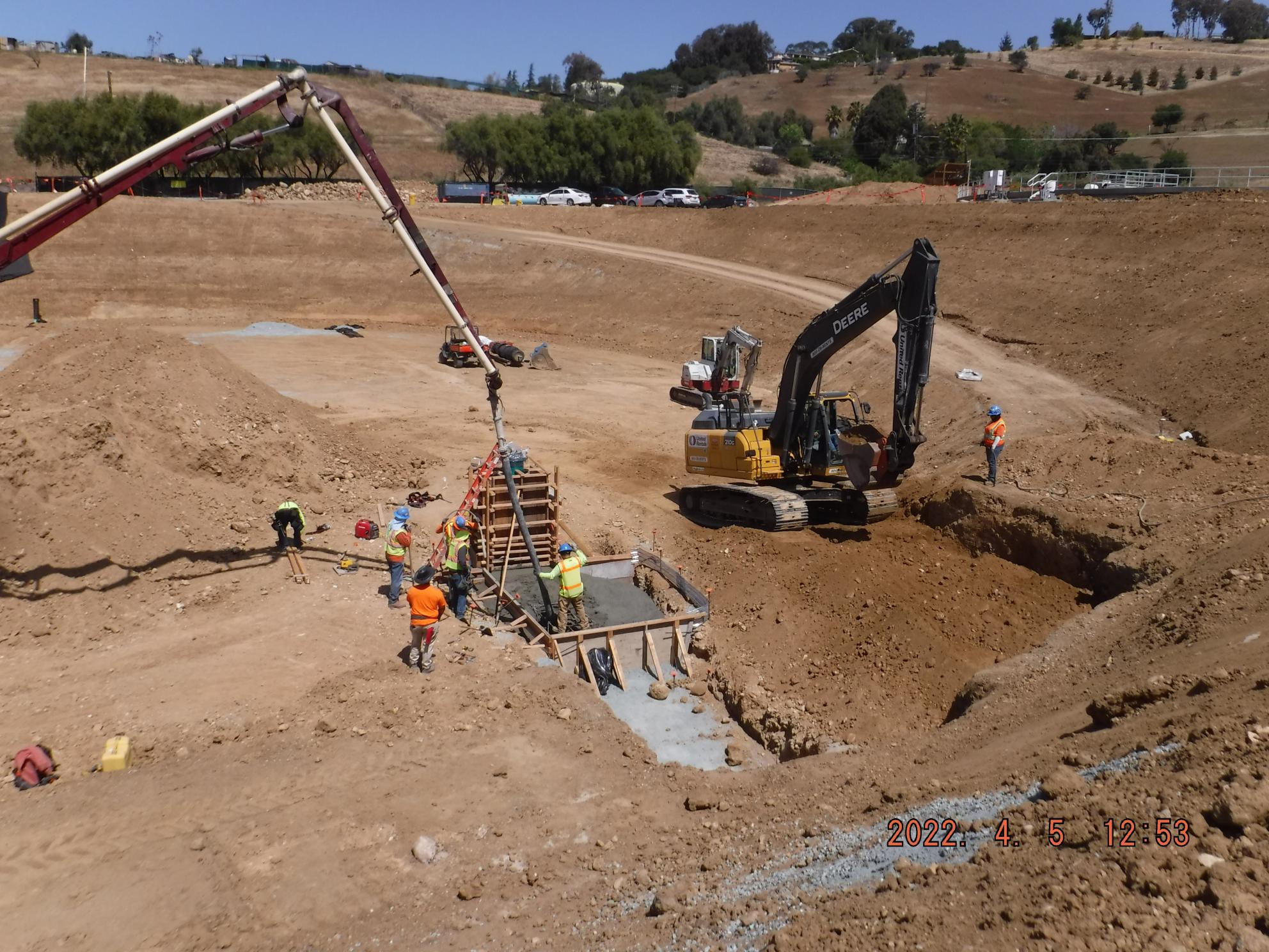 Heavy equipment prepares base of new water tank