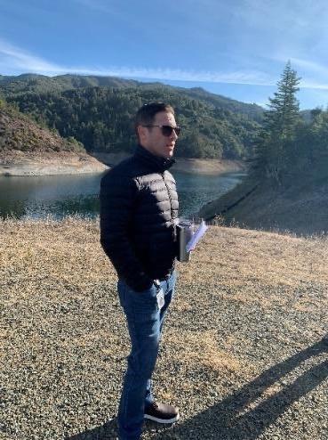 Colby standing in front of a lake