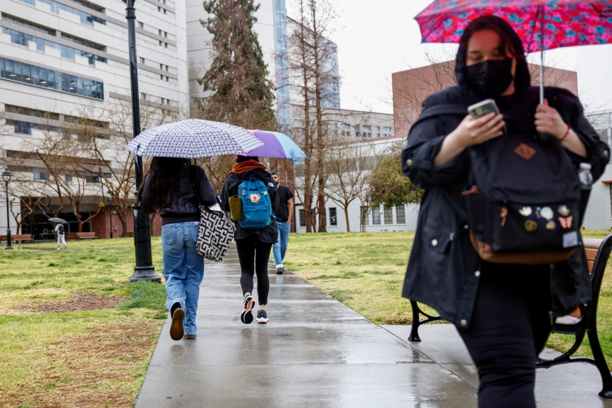 Students walk in the rain at San Jose State on Feb. 27. (Shae Hammond/Hammond/Bay Area News Group)