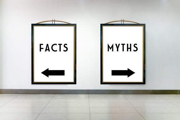 Two signs on a wall, one says Facts and points to the left, the other says Myths and points to the right