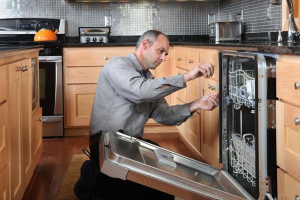 Man repairing dishwasher