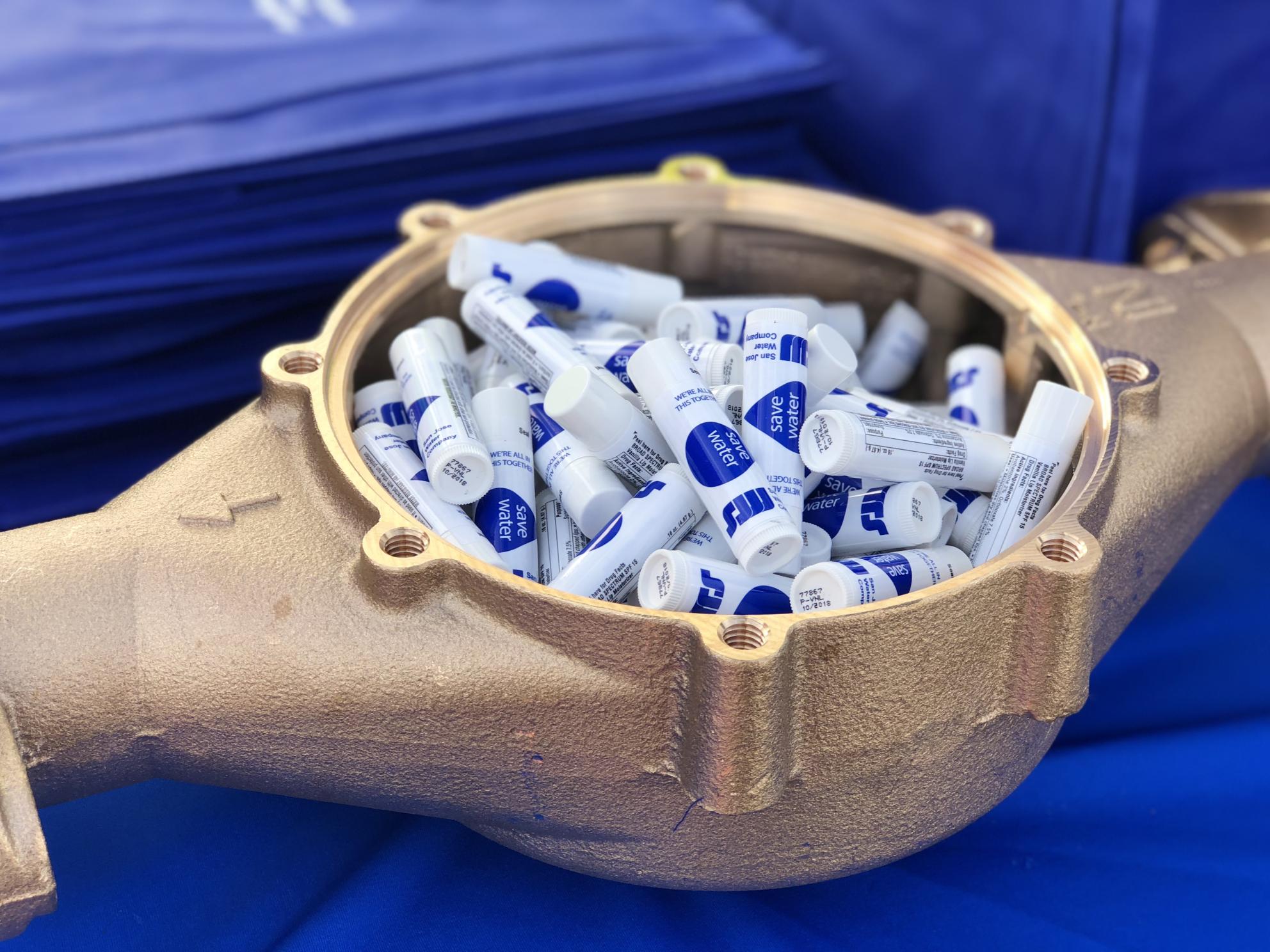 Water meter casing full of lip balms branded with the SJW logo