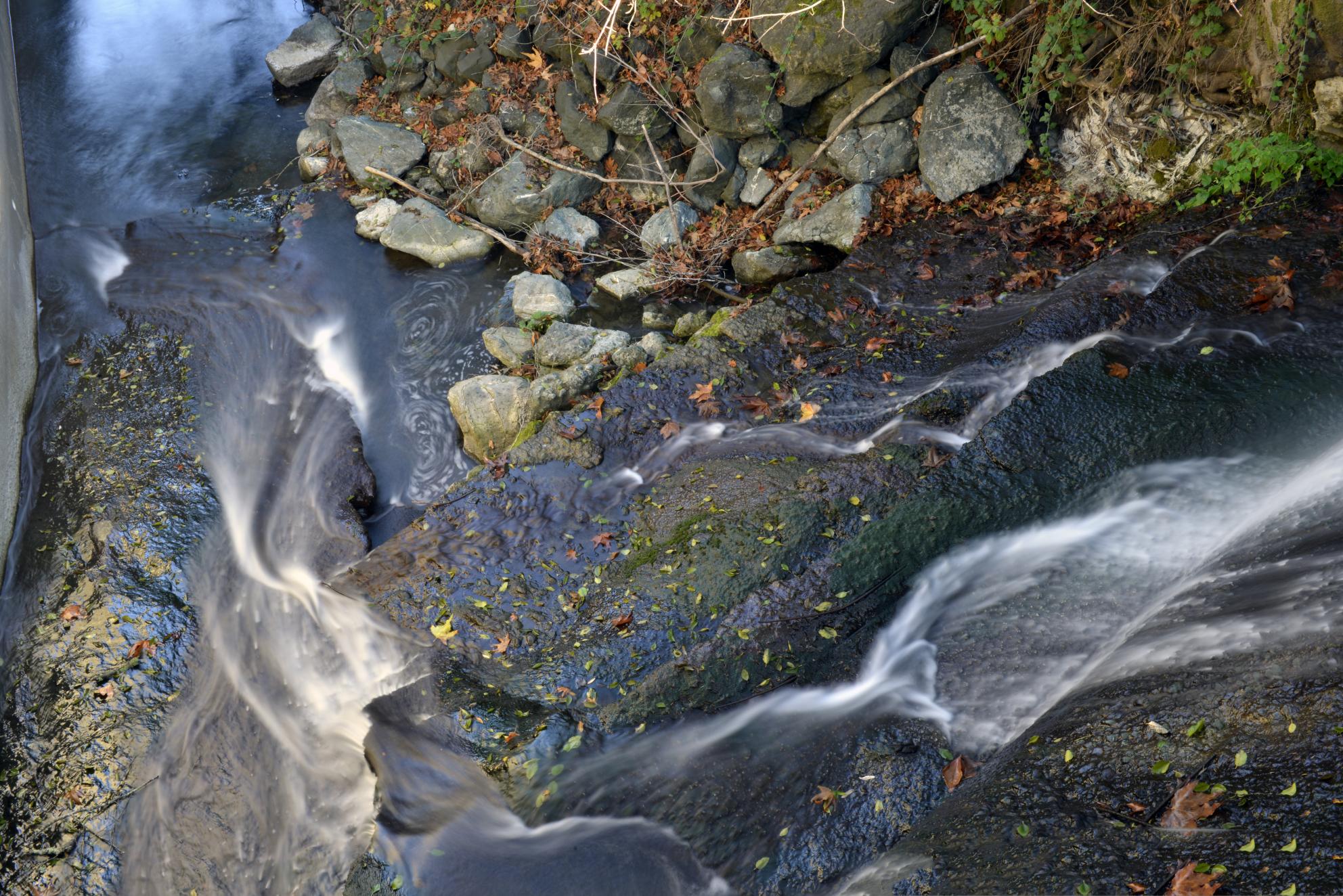 View from above of a rocky, fast moving stream